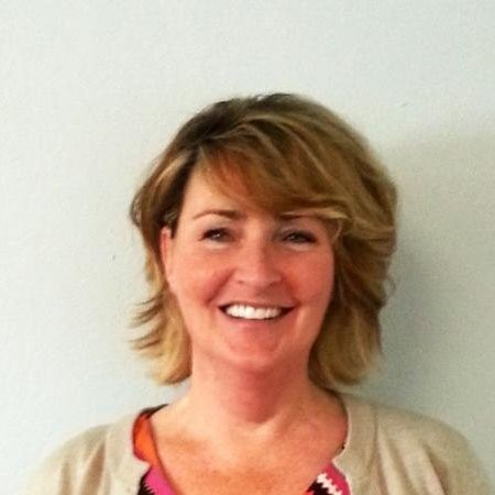 Patricia Salmon smiling into camera wearing beige cardigan