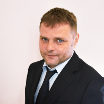 Marco Frangione in dark suit and loose tie.