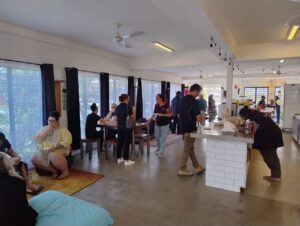 Photo inside the Indigenous Youth Oasis with people talking, eating and socialising.